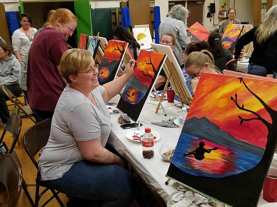 Club participants painting.